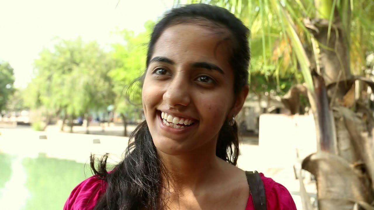 A participant smiling, from the EduRetreat India film